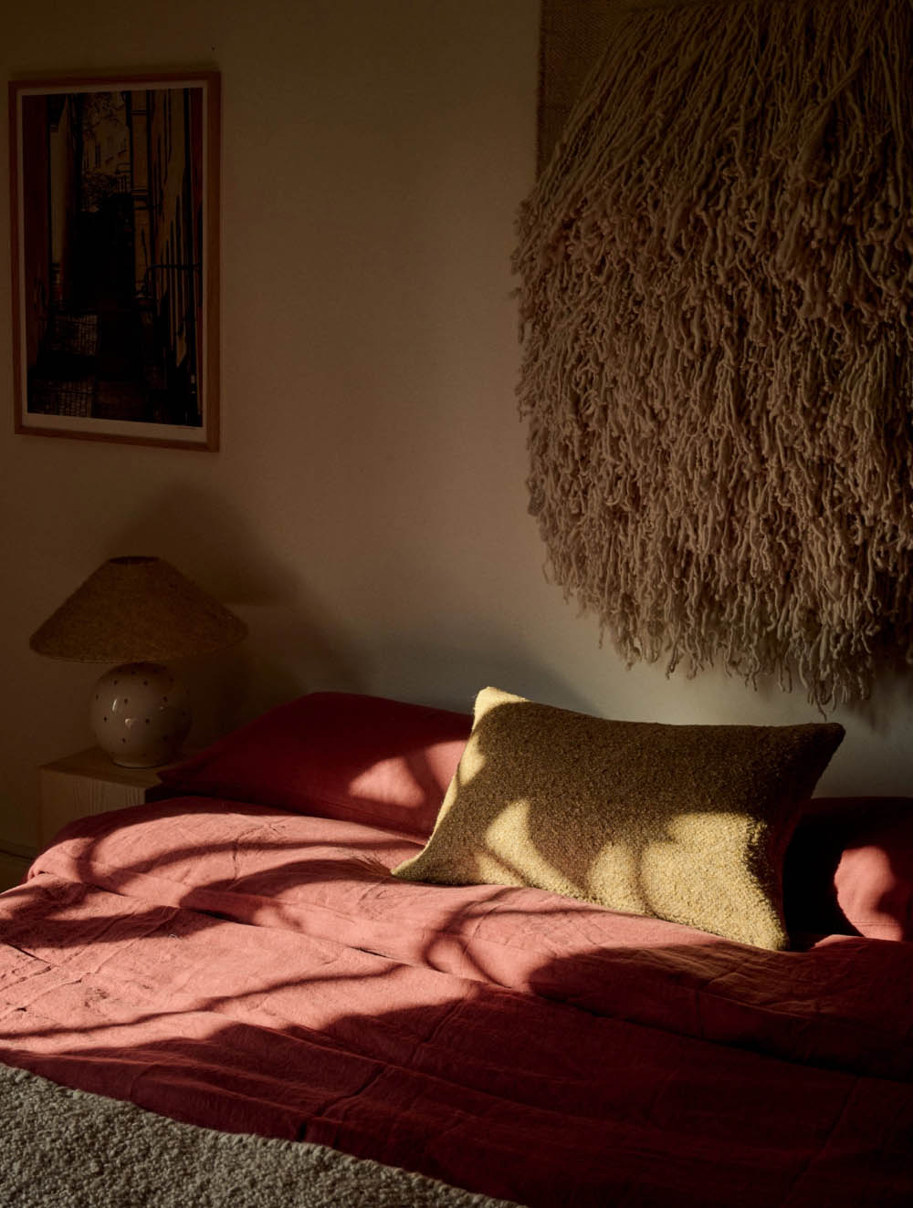 Tambur cushions in Astrid Textiles fabric on a bed